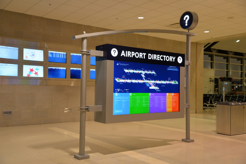 86 inch screen displaying digital signage in DTW Terminal A 
