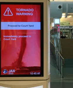 Screen in Jacksonville International Airport (JAX( announcing a tornado warning during a hurricane.