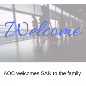 Airport concourse with travelers moving to their gates, with the word welcome laid over top.