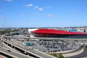 Long distance view of the new Boston Logan Terminal E Façade featuring "Boston Red" prismatic Paint